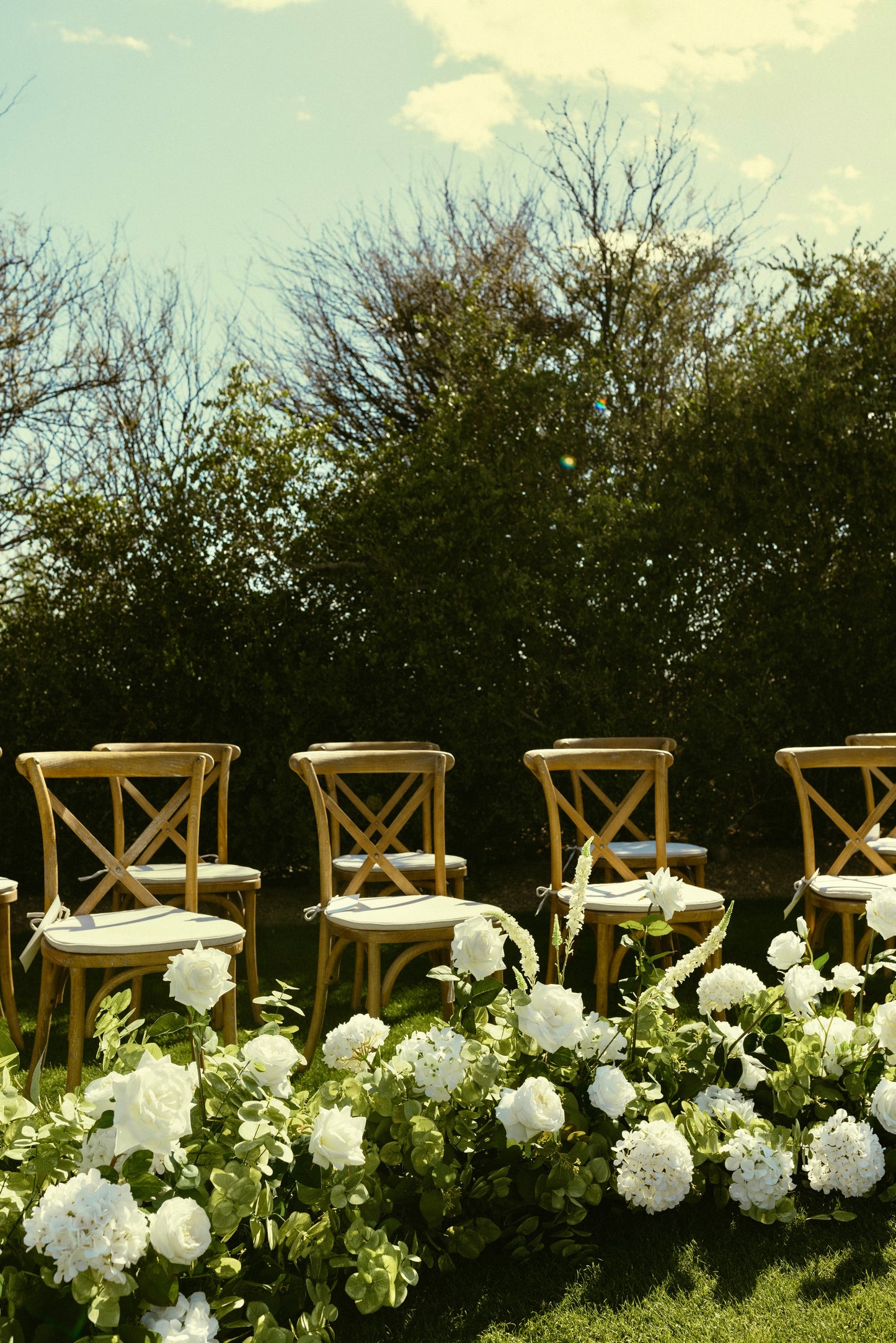 garden-aisle-flowers-with-chairs